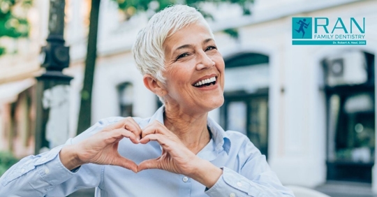 woman holding up heart